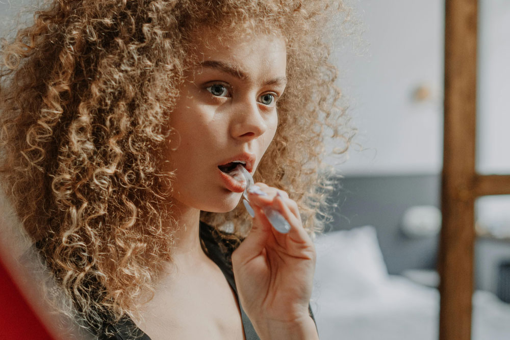 A young woman brushing her teeth
