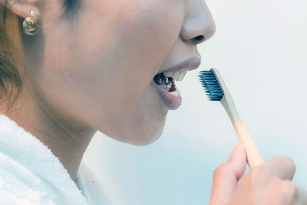 Close up of someone brushing their teeth