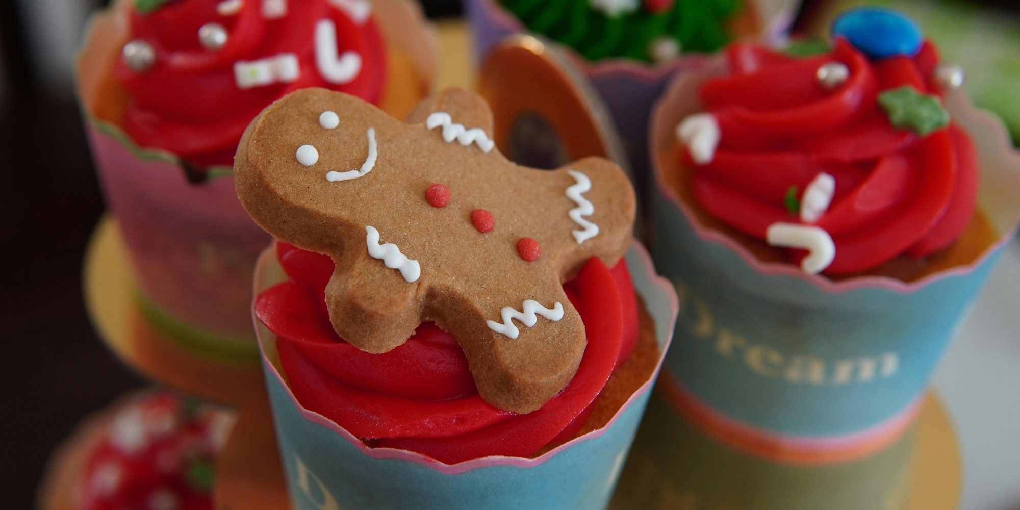 A festive gingerbread man on top of a cupcake