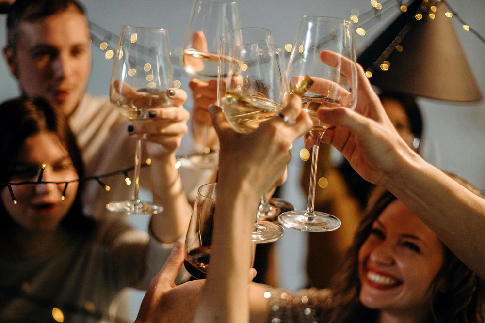 A group of people clinking glasses in a toast